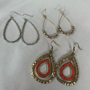 Three pair of tear drop style hoop earrings